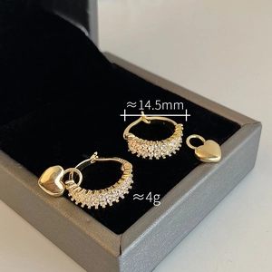 Detailed view of 14.5mm gold hoop earrings with zircon stones and detachable heart charms