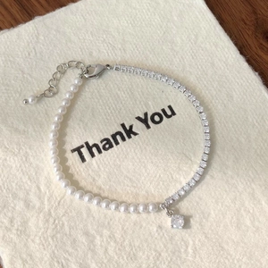 Detail showing pearl and crystal splicing bracelet with adjustable chain on thank you card