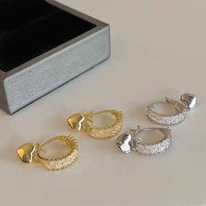 Close-up of S925 silver hoop earrings with zircon heart pendants in gold and silver