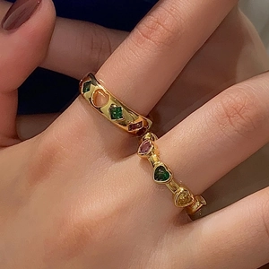 Detail of gold rings with colorful heart zircon stones and star-inspired design