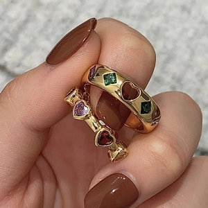 Macro shot of gold-plated double-layer rings set with colorful heart and square zircons