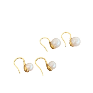 Elegant white pearl drop earrings with gold plated hooks shown in an organized layout