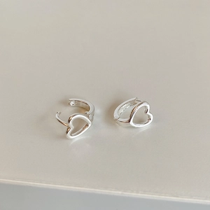 Dettaglio macro di orecchini a cerchio minimalisti a forma di cuore cavo in argento