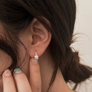 Elegant silver sphere earrings with micro-pave crystals shown on ear lobe