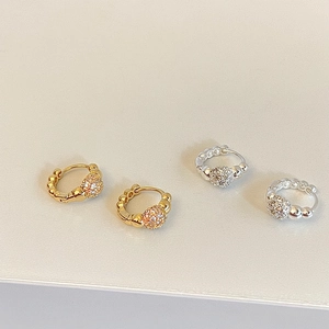 Elegant gold and silver hoop earrings with textured finish and pavé crystal ball charms