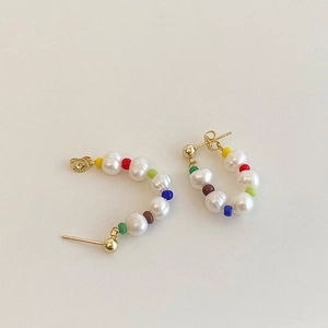 Macro detail of S925 silver studs with colorful beads and white freshwater pearls
