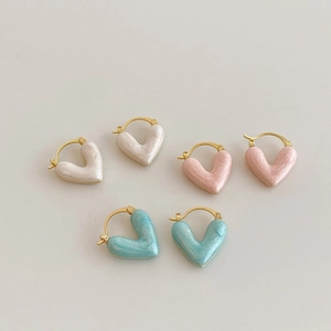 Three pairs of heart earrings in white, pink, and blue with gold plating and pearl glaze