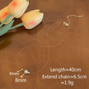 Detailed view of 8mm pearl pendant necklace on transparent line with gold lobster clasp