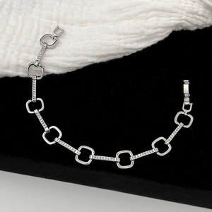 Detail view of silver geometric chain bracelet with micro-pave cubic zirconia accents