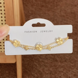 Double-layer gold clover bracelet with cat-eye stone petals and tiny diamond centers