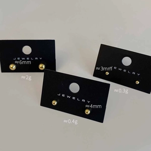 Three pairs of round golden ball stud earrings in 6mm, 4mm, and 3mm sizes shown on a jewelry card