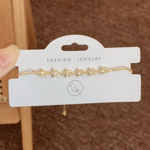 Adjustable gold star bracelet with cubic zirconia charms and sliding bead clasp