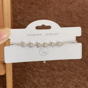 Sparkling zircon star bracelet in silver finish with matching white jewelry display card
