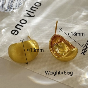 Detailed view of matte brushed gold bean earrings with size and weight measurements