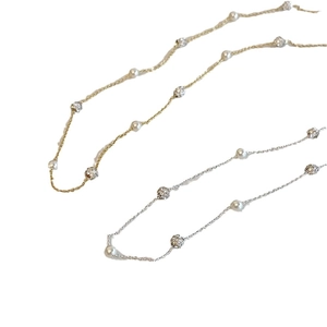 Elegant gold and silver pearl necklaces with shimmering zircon beads on white background