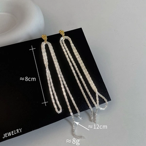 Detail of 8cm and 12cm long gold and silver tassel earrings on black display card