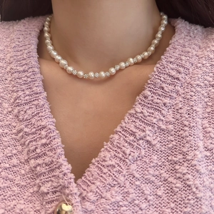 Close-up of elegant freshwater pearl necklace with sparkling pave crystal sphere spacers