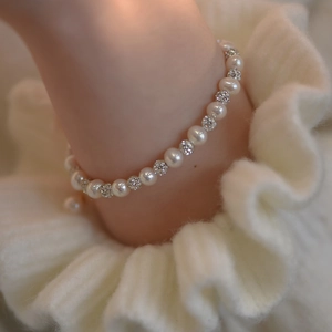 Close-up of elegant freshwater pearl bracelet with micro-pave crystal beads on wrist