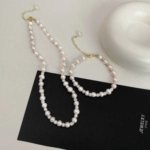 Elegant freshwater pearl necklace and bracelet set with gold plated accents and crystals