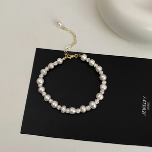 Detail of freshwater pearl bracelet with crystal sphere beads and gold heart charm