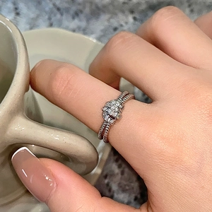 Double-layered knot ring with cubic zirconia in silver-plated minimalist design