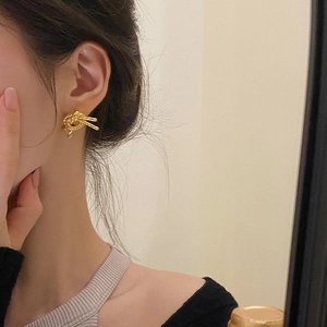 Elegant gold double knot earrings featuring a twisted ribbon design for daily commuter style