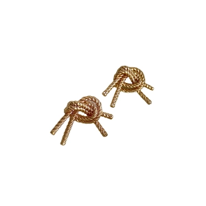 Elegant gold double-layered knot stud earrings with twisted metal texture on white background