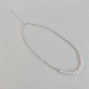 Detail of silver faceted beads and white pearls necklace with adjustable lobster clasp