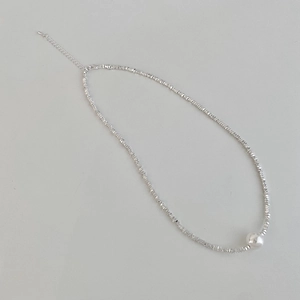 Macro detail of silver irregular beads necklace with white pearl and adjustable clasp