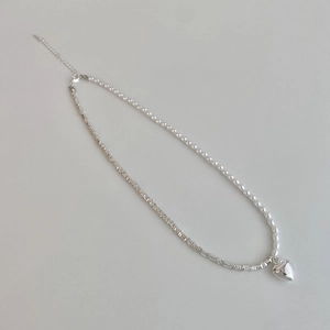Pearls and metallic beads asymmetrical necklace with polished heart pendant charm