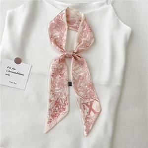 Gros plan détaillé d'un foulard en soie rose à fleurs noué en boucle élégante