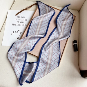 Detailed view of silk-like neckerchief with red diamond pattern and blue borders