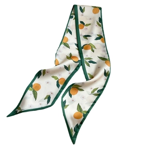 Narrow silk scarf for women featuring orange fruit print and dark green border on white base