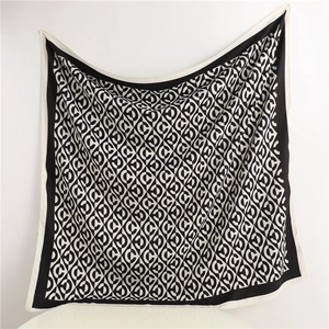 Detailed view of 90cm silk scarf with black and white C-pattern geometric print