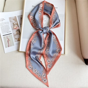 Blue and coral floral satin scarf tied as an elegant hair ribbon or necktie accessory