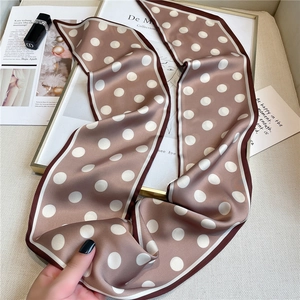 Detailed view of polka dot long silk scarf with contrast edges and soft satin texture