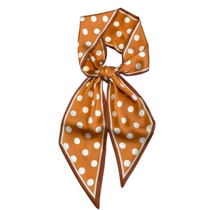 Classic orange polka dot silk neck scarf with a smooth satin finish in a stylish tie knot