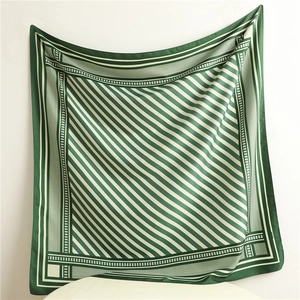 Close-up of green and white geometric pattern on high-quality twill silk scarf detail