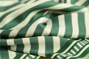 Macro detail of high-quality silk scarf fabric with green and white stripes and soft shine
