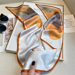 Détail d'un foulard en soie artistique aux motifs abstraits dans des tons de terre