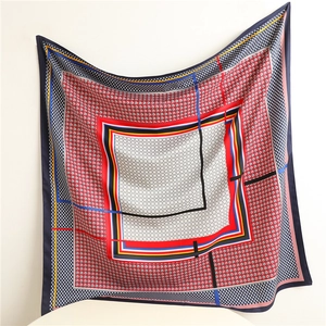 Detail of colorful houndstooth silk scarf showing smooth texture and geometric pattern