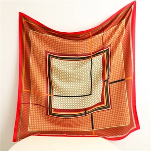 Detailed pattern of a large silk square scarf featuring houndstooth and geometric prints