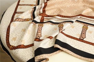 Macro detail of high-quality silk scarf featuring equestrian belt patterns and horse motifs