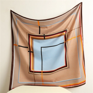 Close-up of houndstooth pattern and geometric color blocks on a 90cm square silk scarf