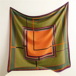 Detail view of square silk scarf with houndstooth pattern and color block edges