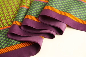 Detail of soft silk-like fabric showing houndstooth patterns and purple color block