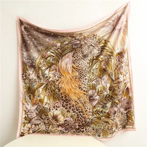 Detailed close-up of a large square scarf featuring a leopard and sun-moon motifs