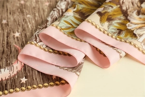 Detailed view of 90cm square silk scarf with moon star patterns and twill texture