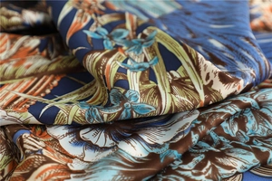 Close-up of tropical floral print on navy silk scarf with detailed twill weave texture