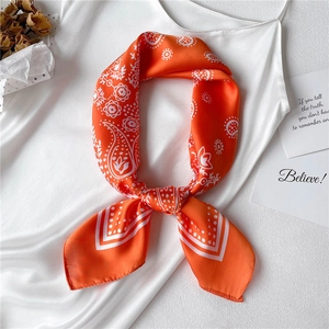 French retro orange paisley silk scarf for women styled on a white satin dress